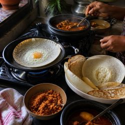 Traditional Sri Lankan breakfast of hoppers and curry being prepared